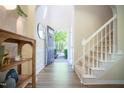 Bright foyer with a staircase and open doorway leading to a sunny exterior, enhancing the welcoming ambiance at 3303 Silver Star Dr, Durham, NC 27713