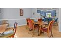 Light-filled dining room featuring hardwood floors, a wood table with seating, and blue accent walls at 3308 Churchill Rd, Raleigh, NC 27607