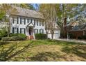 Charming two-story home with white siding, dark shutters, and a well-maintained front yard at 3308 Churchill Rd, Raleigh, NC 27607