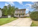 Inviting home with a front porch, a well-kept lawn, and convenient driveway access at 34 Stuart Dr, Benson, NC 27504