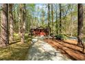 Secluded home surrounded by a tranquil forest setting with a gravel driveway at 3508 Cole Mill Rd, Durham, NC 27712