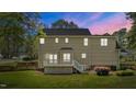 The back exterior shows a two-story siding with a deck overlooking a well-kept lawn and lush surroundings at 3517 Boren Ct, Raleigh, NC 27616