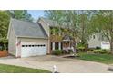 Charming two-story brick home with an attached garage, well-manicured lawn, and a brick-paved front walkway at 3517 Boren Ct, Raleigh, NC 27616