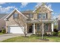 Charming two-story brick home with a two car garage and well-manicured lawn at 360 Callandale Ln, Durham, NC 27703