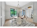 Elegant dining room featuring a round table, stylish chandelier, and a large window at 3832 Noremac Dr, Raleigh, NC 27612
