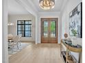 Bright foyer with beautiful wood floors, a decorative table, and a view to the dining room at 3832 Noremac Dr, Raleigh, NC 27612