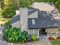 View of the home's exterior with a stone walkway, and lush greenery at 3900 Maplefield Dr, Raleigh, NC 27613