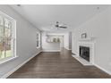Spacious living room with hardwood floors, a fireplace, and a ceiling fan at 420 Feldspar Way, Durham, NC 27703