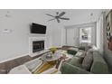 Bright living room features a marble fireplace, ceiling fan, and modern furnishings at 420 Feldspar Way, Durham, NC 27703