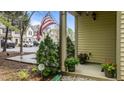 Cozy covered front porch, adorned with colorful potted plants at 4523 Tarkiln Pl, Wake Forest, NC 27587