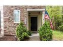 Inviting front entry of home showcasing stone details and decorative landscaping at 4523 Tarkiln Pl, Wake Forest, NC 27587