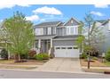 Beautifully landscaped two-story home with a covered porch, a two-car garage and mature trees at 463 Old Piedmont Cir, Chapel Hill, NC 27516