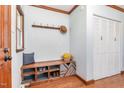 Cozy entryway featuring a built-in bench with storage, coat hooks, and a closet for organization at 5033 Green Oak Dr, Durham, NC 27712
