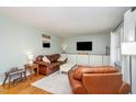 Comfortable living room with hardwood floors, leather furniture, and built-in cabinets at 5033 Green Oak Dr, Durham, NC 27712