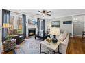 Comfortable living room features a cozy fireplace, plush seating, and bright windows at 504 Skygrove Dr, Holly Springs, NC 27540