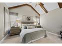 Tranquil main bedroom with vaulted ceilings, exposed beams, and neutral decor at 504 Skygrove Dr, Holly Springs, NC 27540