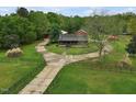 Charming home with a circular driveway and lush green lawn, providing a serene setting at 5069 Cokesbury Rd, Fuquay Varina, NC 27526