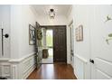 Inviting foyer with hardwood floors, white wainscoting, and an open view of the front door and exterior at 515 Bexley Bluff Ln, Cary, NC 27513