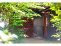 Charming home entrance with brick walkway, rustic wood siding, and decorative butterfly accent at 518 Morgan Creek Rd, Chapel Hill, NC 27517