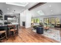 Bright open-concept living space with hardwood floors, skylights, fireplace, and access to outdoor patio at 518 Morgan Creek Rd, Chapel Hill, NC 27517