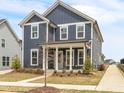 Attractive two-story home with blue siding, white trim, and a welcoming front porch with classic pillars at 5712 Agrinio Way, Raleigh, NC 27603