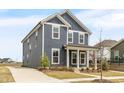 Beautiful two-story home featuring a well-kept lawn, long driveway, and classic architectural details at 5712 Agrinio Way, Raleigh, NC 27603
