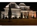 Well-lit two-story home boasts an elegant front yard and classic architectural details at 7825 Green Hope School Rd, Cary, NC 27519