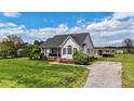 Beautiful home featuring a well-maintained lawn, convenient driveway, and inviting outdoor deck at 82 Sommerset Dr, Clayton, NC 27520