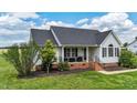 Charming single-story home featuring a welcoming front porch and a well-manicured lawn at 82 Sommerset Dr, Clayton, NC 27520