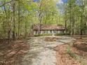Secluded single-story home nestled in a wooded area with mature trees providing shade and privacy at 922 Royal Oaks Dr, Durham, NC 27712