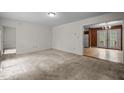 Neutral living room offers a view into the dining area with access to the outdoor space at 922 Royal Oaks Dr, Durham, NC 27712