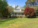 Charming two-story home with a welcoming front porch and well-manicured landscaping at 104 Glenview Pl, Chapel Hill, NC 27514