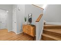 Inviting foyer featuring hardwood floors, a stylish console table, and a staircase at 104 Glenview Pl, Chapel Hill, NC 27514