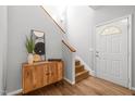 Inviting foyer featuring hardwood floors, a stylish console table, and a staircase at 104 Glenview Pl, Chapel Hill, NC 27514