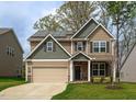 Charming two-story home with a two-car garage, stone accents, and solar panels on the roof at 108 Pronghorn Deer Ct, Garner, NC 27529