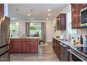 Gourmet kitchen with a large island, stainless steel appliances, and seamless connection to living spaces at 108 Pronghorn Deer Ct, Garner, NC 27529