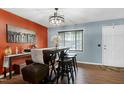 Bright dining area with bar seating, modern chandelier, and an open, airy feel at 1105 Terrace Ct, Raleigh, NC 27615