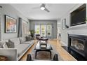 Bright and airy living room with a fireplace, hardwood floors, and ample natural light at 119 Weaver Mine Trl, Chapel Hill, NC 27517