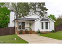 Beautiful cottage-style home featuring black trim, a cozy porch, and a green lawn at 120 Cabrita Ct, Holly Springs, NC 27540