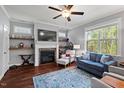 Comfortable living room with fireplace, large windows, and stylish furnishings at 1211 Yellow Wood Dr, Mebane, NC 27302