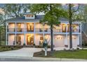 Charming two-story house with inviting balconies and exterior lights, creating a warm ambiance at 1213 Rocky Point Ln, Durham, NC 27712
