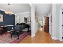 Elegant living room with hardwood floors, piano, and neutral paint colors, great for entertaining at 1310 Country Club Dr, Durham, NC 27712