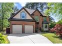 Charming two-story brick home featuring a two-car garage and a well-manicured lawn at 132 Wheatsbury Dr, Cary, NC 27513