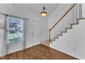 Bright entryway with hardwood floors, stairs to the second floor, and natural light at 1323 Fairmont St, Durham, NC 27713