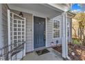 Inviting front porch with a dark blue door, trellis, and security system at 1323 Fairmont St, Durham, NC 27713