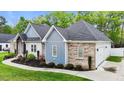 Charming single-story home with brick, siding, and a well-manicured lawn at 1325 George Bason Rd, Graham, NC 27253
