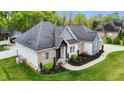 Attractive single-story home with lush landscaping and a brick and light blue siding facade at 1325 George Bason Rd, Graham, NC 27253