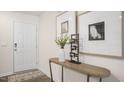Inviting entryway with a modern console table, stylish decor, and a welcoming white door, enhanced by natural light at 134 Holmes Corner Dr, Smithfield, NC 27577