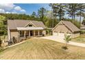 Charming home with a covered front porch, attached garage, and well-maintained lawn at 1422 Gormly Cir, Sanford, NC 27330