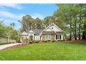 Beautiful home with a well-manicured lawn and lush landscaping at 1537 Heritage Club Ave, Wake Forest, NC 27587